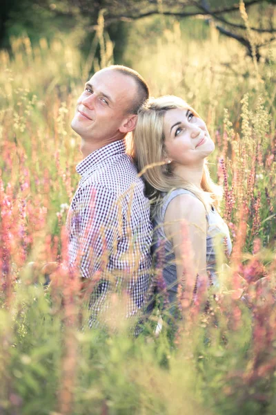 Casal jovem no verão na natureza. O conceito de relacionamentos, amor e relaxamento . — Fotografia de Stock