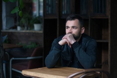 İçerideki sakallı bir gencin portresi..