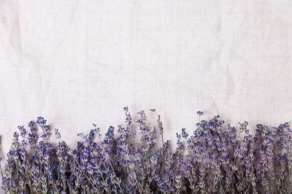 Beautiful floral background with lavender on a fabric background, top view. Rustic or vintage background. Hight quality photo