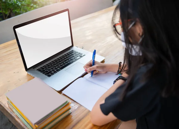 Junior high school girl Do homework at home Because the school is closed Due to the severe outbreak of the Corona virus Covid-19 and Dust PM2.5 in Bangkok Thailand