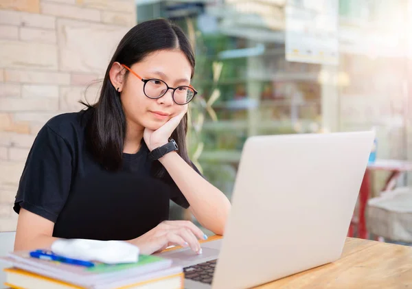 Junior high school girl Do homework at home Because the school is closed Due to the severe outbreak of the Corona virus Covid-19 and Dust PM2.5 in Bangkok Thailand