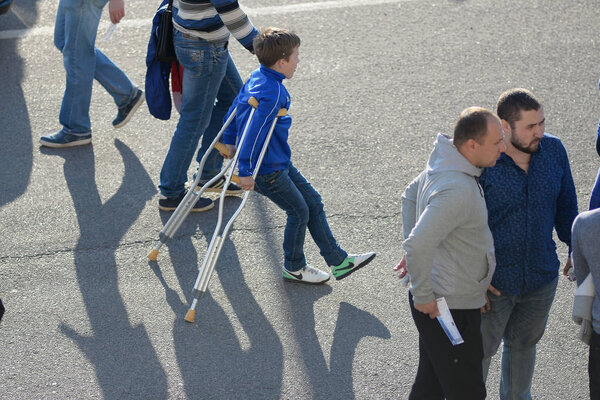 MINSK, BELARUS - MAY 23, 2018: Little fan on crutches with a leg injury before the Belarusian Premier League football match between FC Dynamo Minsk and FC Bate at the Tractor stadium.