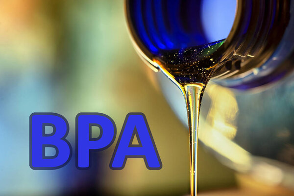 Plastic bottle and liquid stream. Bisphenol, text BPA FREE plastic photo