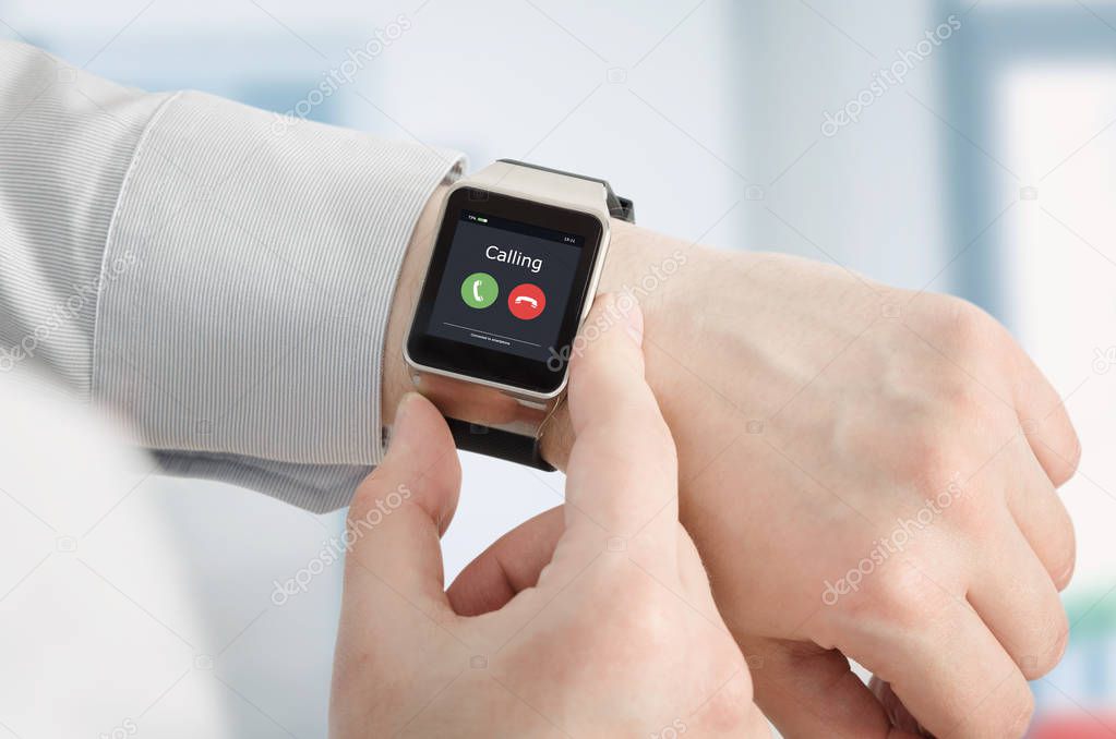 Smartwatch on hand, incoming call on screen, conversation via a smart watch concept