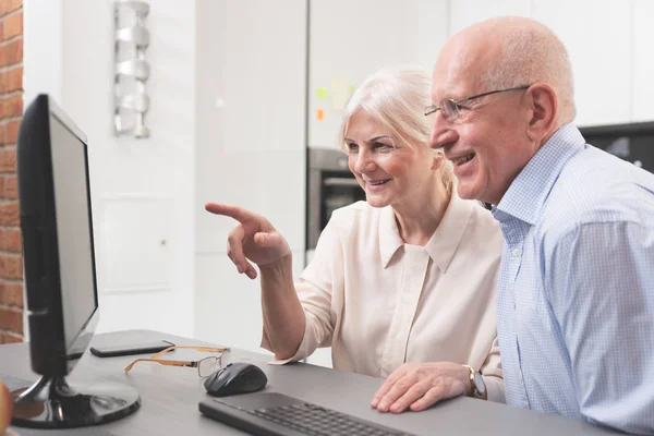 Gelukkige oudere echtpaar genieten samen op computer — Stockfoto