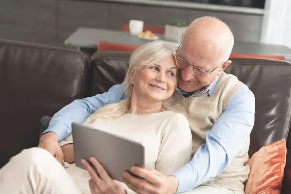 Grandparents using social media on tablet