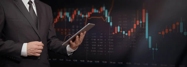 Investor with tablet, stock market background — Stock Photo, Image