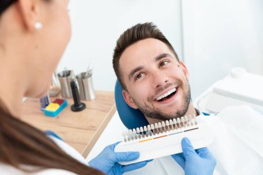 Stomatolojinin kliniğinde yakışıklı genç adam