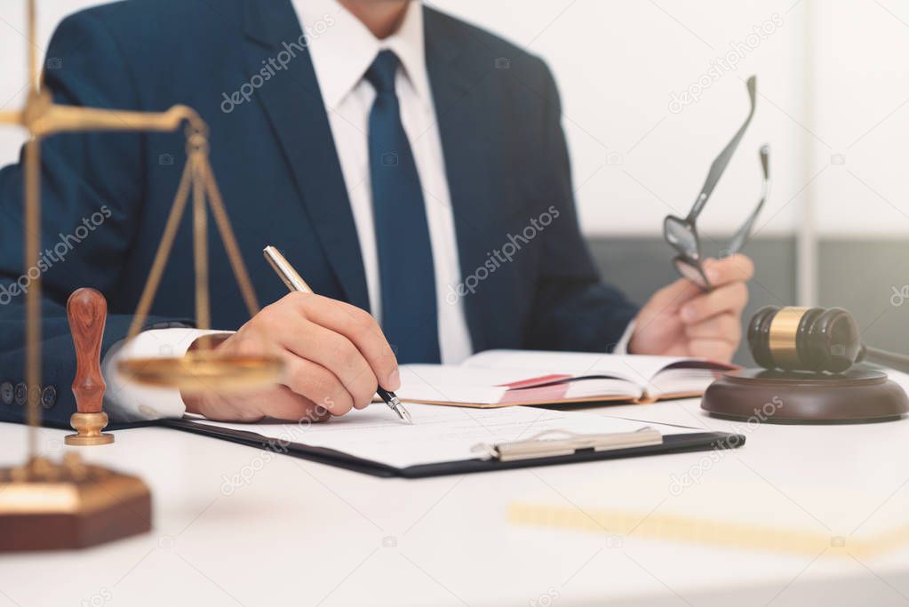Lawyer or attorney working with papers in office