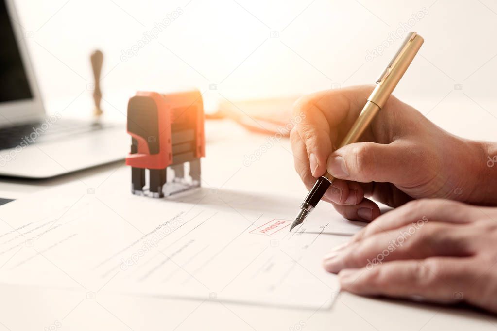 Lawyer working in office. Notary signs document