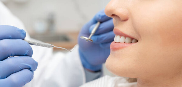Young woman in stomatology clinic. Dental health, teeth whitening concept.