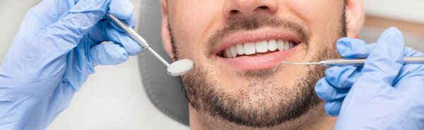 Man having teeth examined at dentists. Overview of dental caries prevention