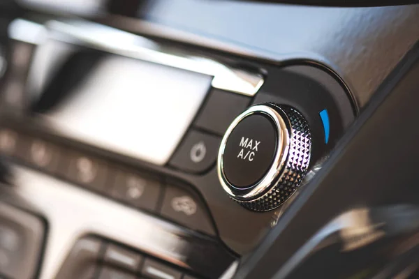 Air conditioner control panel, car cooling system. Close up photo of front panel with AC knob