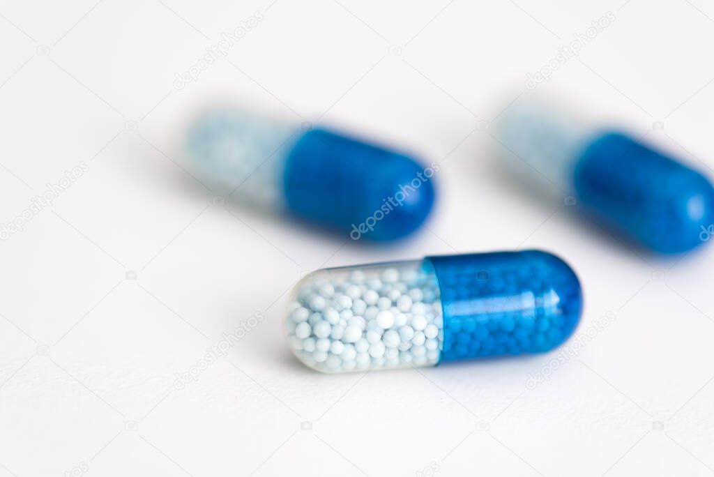 Blue capsule, pills on white background. Health care, medical, pharmacy concept