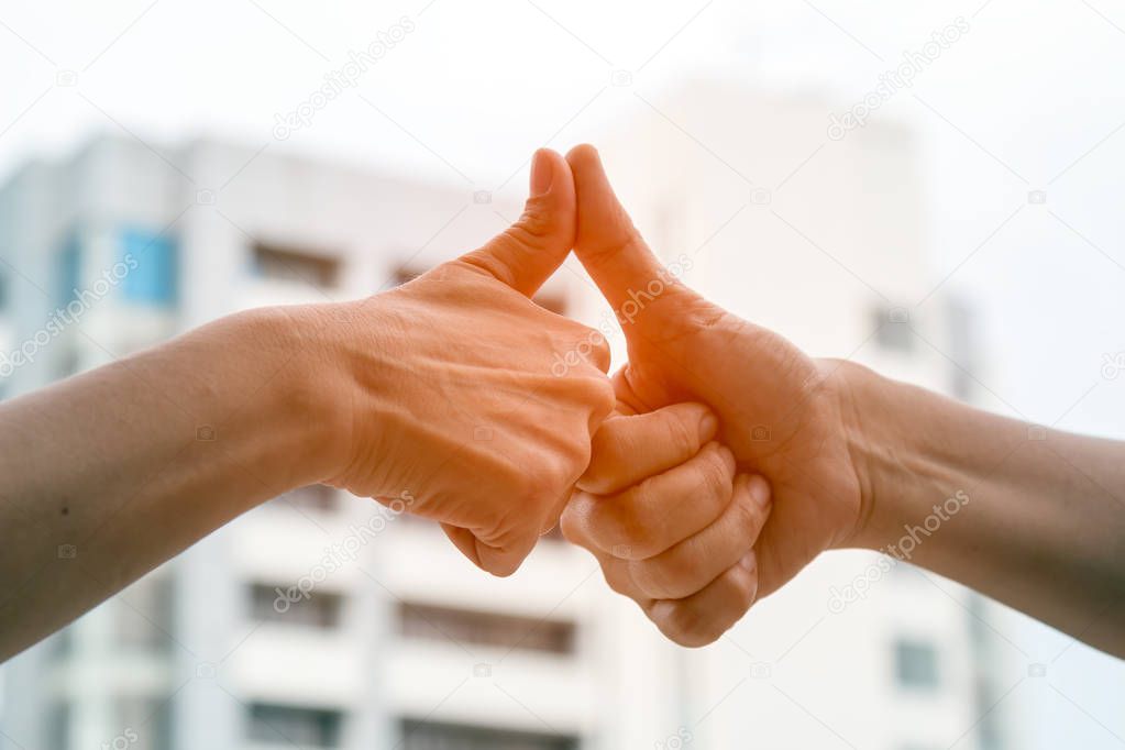 Close up of Thumb finger touching from 2 men after agreement