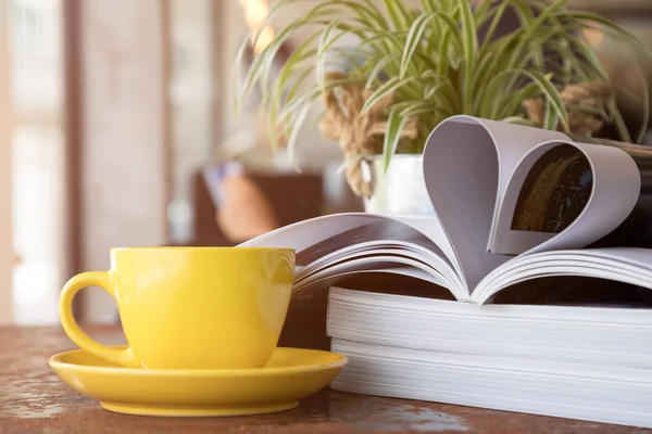 Close Yellow Coffee Cup Placing Together Magazine Heart Shape — Stock Photo, Image
