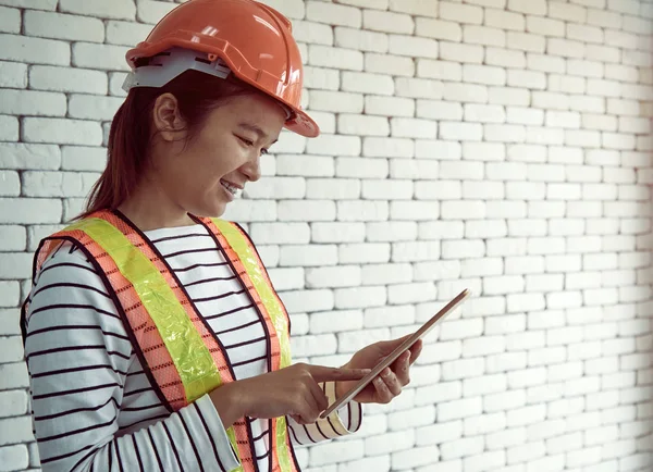 Security officer hold tablet and check the data with smiling