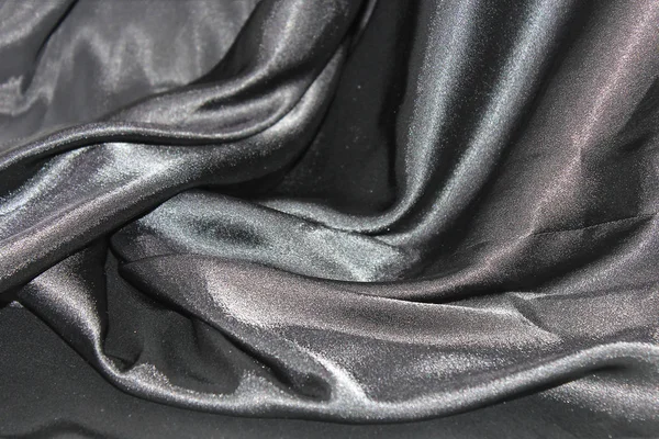 お祭りの背景として灰色の絹の布の起伏のあるひだ — ストック写真