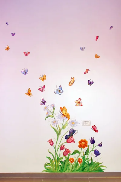 colorful butterflies fly over flowers, drawing on the wall in the children\'s room