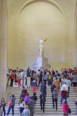 PARIS, FRANCE -23 may 2018: tourists take pictures Winged Victory of Samothrace, called Nike of Samothrace, the Daru staircase, Louvre Museum in Paris clipart