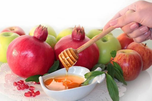 apples, honey and pomegranates, traditional foods to celebrate jewish new year - holiday of Rosh Hashanah