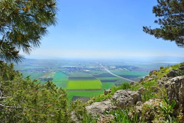 views of the Jezreel Valley from the heights of Mount Precipice, located just outside the southern edge of Nazareth, Lower Galilee, Israel clipart