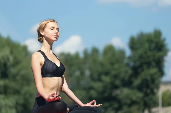 Yoga woman with closed eyes meditaiting.