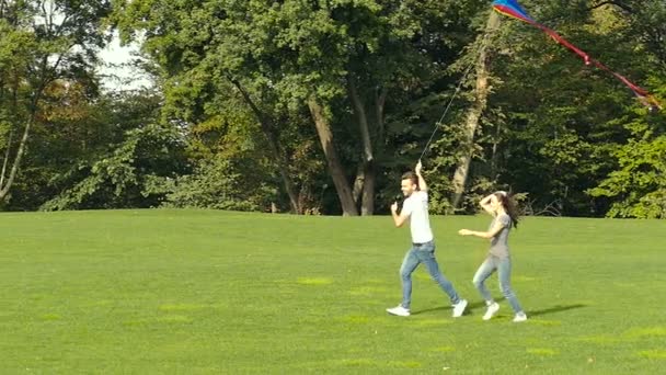 Couple Playing Air Kite Outdoors Slowmotion — Stock Video