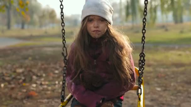 Poor Homeless Little Girl Sitting Swing Looking Camera — Stock Video