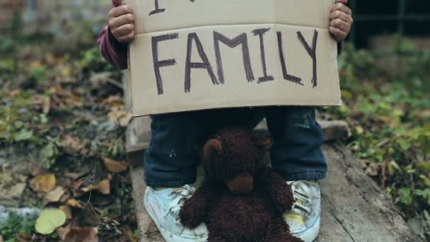 Homeless Child Outdoors Holding Cardboard Sign Need Family — Stock Video
