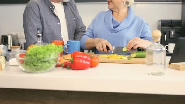 Pensioner Couple Preparing Side Dish Together Wife Cutting Cucumber Giving — Stock Video
