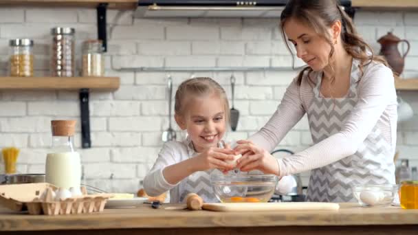 Mother Daughter Smiling Laughing While Beaking Egg Bowl Together Cooking — Stockvideo