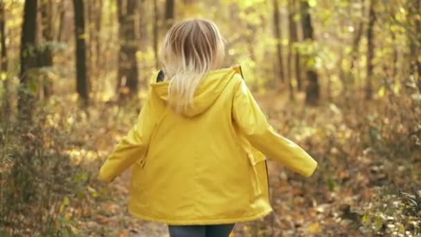 Smiling Blonde Woman Having Fun Running Autumn Forest Turns Looking — Stock Video