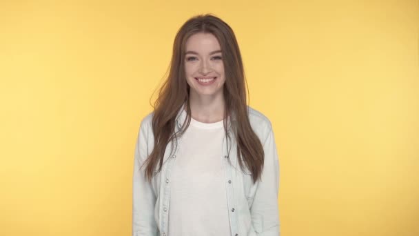 Smiling Young Woman Looking Camera Yellow Background — Stock Video