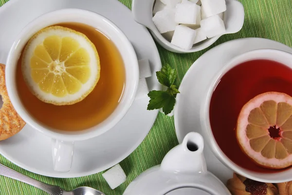 two lemon and forest teas with lemon and sugar cubes