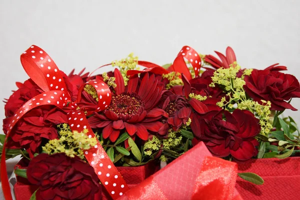 a red bouquet with flowers of gerberas and carnations
