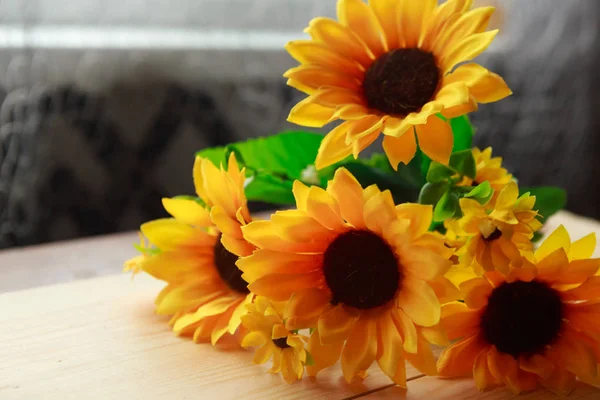 bouquet of sunflowers on wooden background