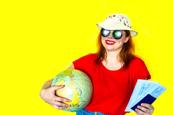 Portrait of redhead girl with globe and documents in her hands. Travel concept. Copy space, banner