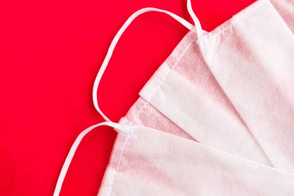 Medical masks on red background, covid-19 concept, closeup