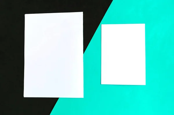 Two white mockup blanks on geometric turquoise and black background. Copy space for the text. Vertical