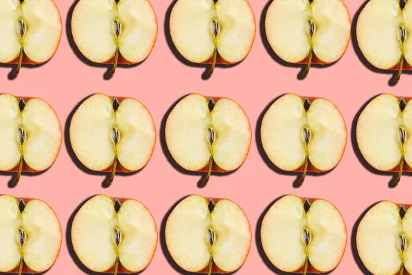 Sliced apple pattern on pink background, minimal concept
