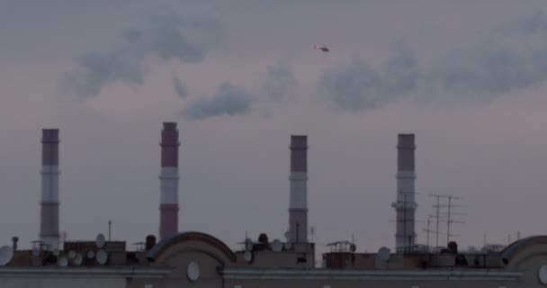 Smoking chimneys and a helicopter — Stock Video