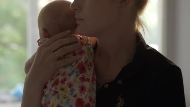 Loving and careful mother with baby daughter at home — Stock Video