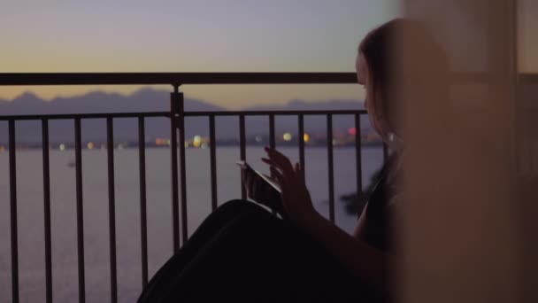 바다 풍경에 대 한 발코니에 젊은 여자 — 비디오