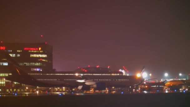 Aeroflot vliegtuigen en Terminal F van Sheremetyevo Airport, weergave van de nacht. Moskou — Stockvideo