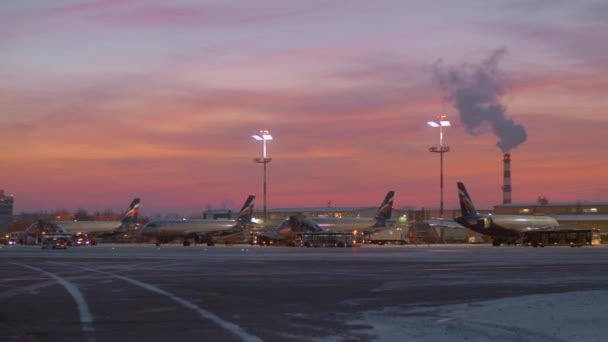 Plocha letiště Šeremetěvo s letadla a vozidla na úsvitu v zimě — Stock video