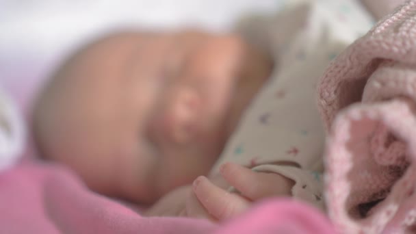 Newborn baby girl asleep in her crib — Stock Video