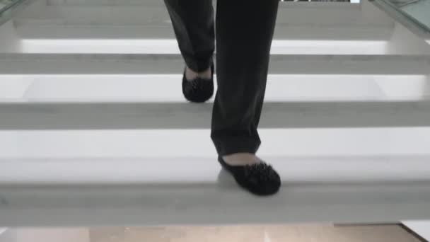 Steadicam-Aufnahme weiblicher Füße, die die Treppe hinuntergehen — Stockvideo