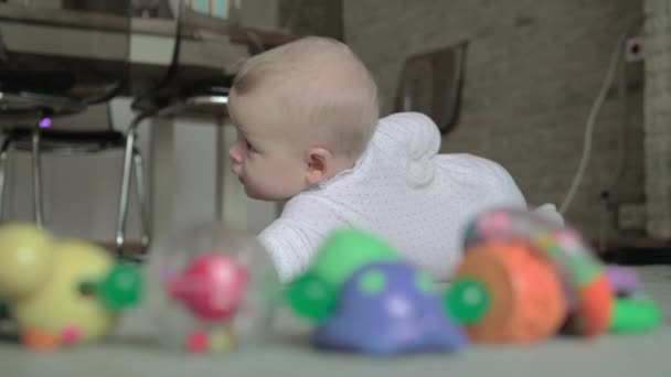 Schattig babymeisje spelen op het tapijt — Stockvideo