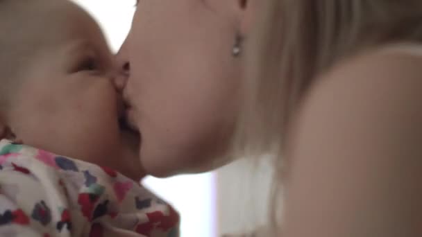 Baby being held and kissed by her mother — Stock Video